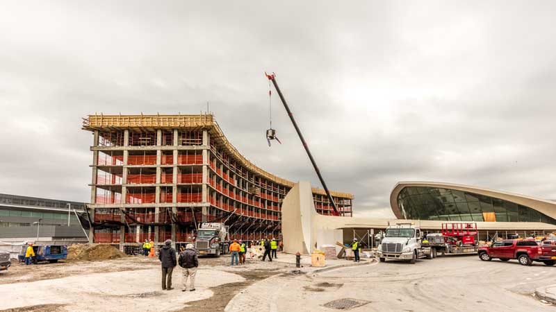 Less Than a Year After Groundbreaking, MCR & Morse Development Top Out the TWA Hotel New York Airport 2 TWA Topping Out TWA Hotel flag and American flag raised by crane above the north hotel structure Max Touhey Metropolitan Airport News