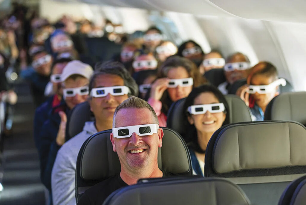 Gazing Skyward… Wearing eclipse glasses gifted by Alaska Airlines, passengers watched the entire event unfold from their seats above the earth.