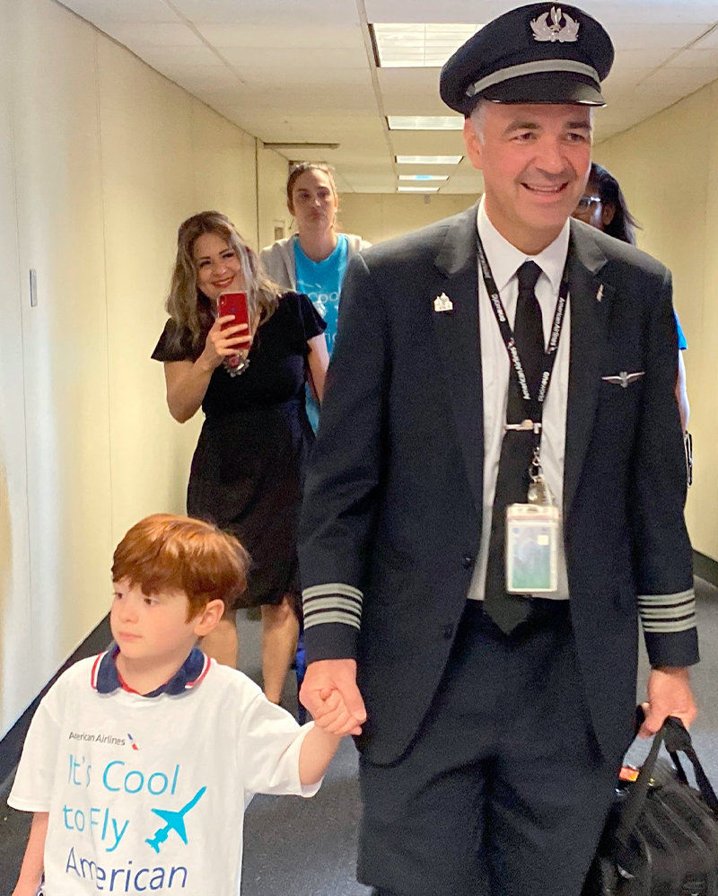 An American Airlines captain with his son after volunteering for the ICTFA flight crew