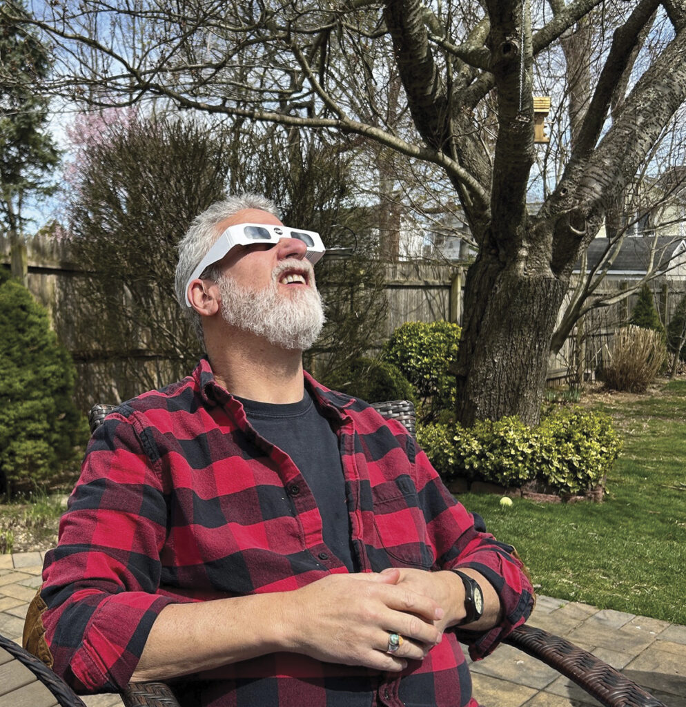 Gazing Skyward... New York Airport Doug Blum taking in the solar eclipse from the ground in our Long Island, NY backyard.