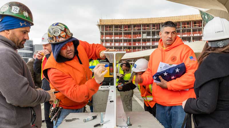 Less Than a Year After Groundbreaking, MCR & Morse Development Top Out the TWA Hotel New York Airport 6 TWA Topping Out Workers signing the ceremonial steel beam Max Touhey Metropolitan Airport News