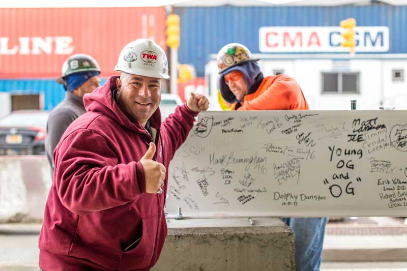 Less Than a Year After Groundbreaking, MCR & Morse Development Top Out the TWA Hotel New York Airport 7 TWA Topping Out TWA Hotel construction worker next to the steel beam Max Touhey Metropolitan Airport News