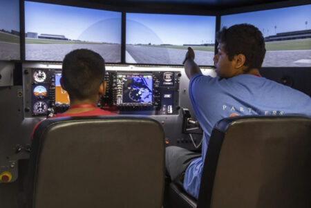 Students in the JFK Aviation and Aeronautics Academy at York College train on the college's flight simulators.