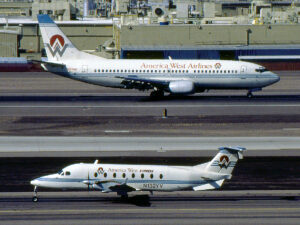 America West Boeing 737-300 and America West Express Beechcraft 1900D. New York Airport America West Boeing 737-300 and America West Express Beechcraft 1900D.