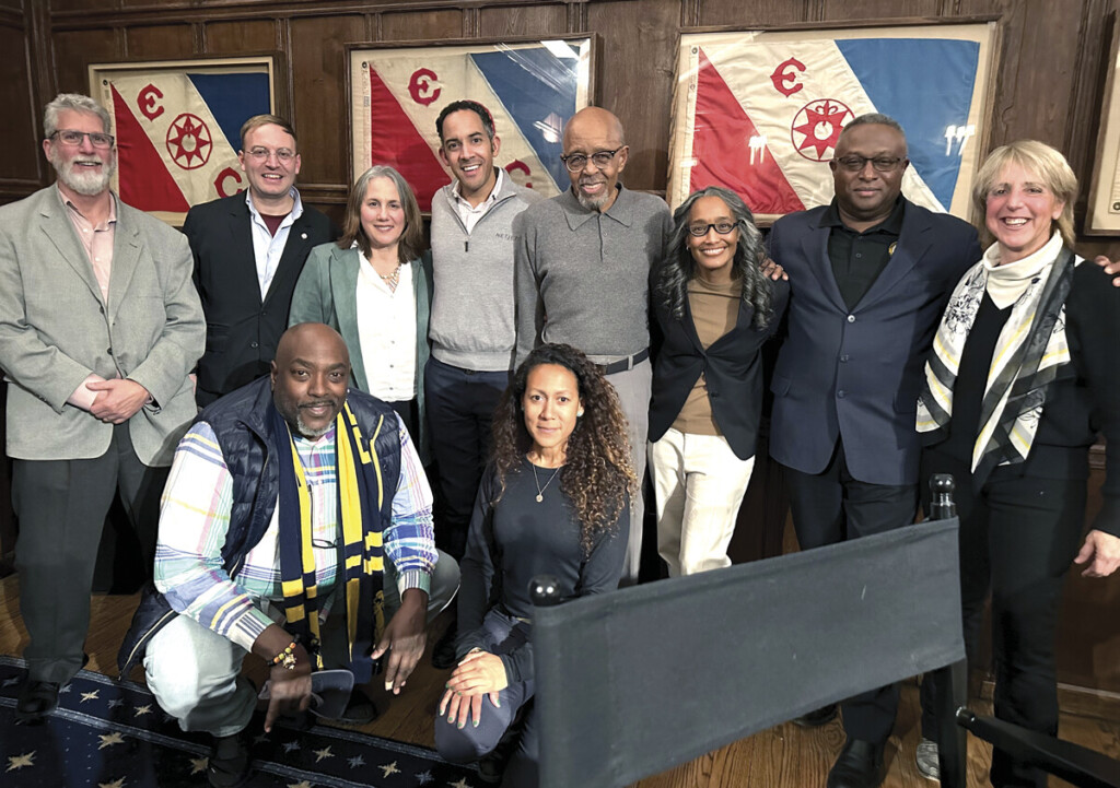 “Every No Takes Me Closer to Yes” Members of the Explorer’s Club and attendees pose in front of retired flags carried on major scientific expeditions. Today, there are over 200 numbered flags, each with its own history on display.