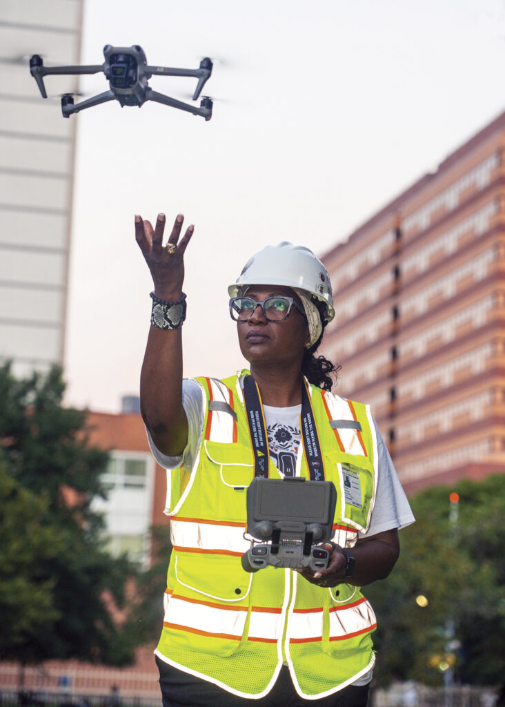 A drone ascends from the hand of drone photographer, Beverly Holder.
