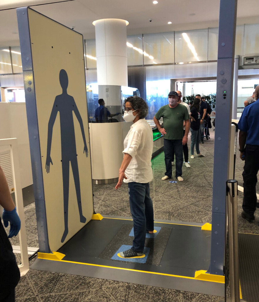Body scanners with hands down at LGA Airport.
