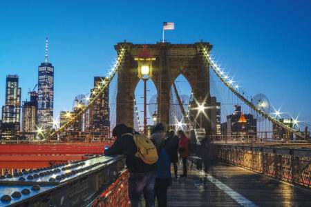 The Allure of New York City The Brooklyn Bridge offers stunning views of the Manhattan skyline, with iconic landmarks like One World Trade Center and the Empire State Building prominently featured. (Julienne Schaer)