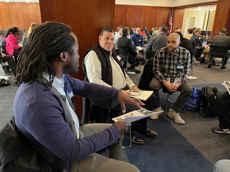 Joseph Dabo, left, got his job at Macquarie through Edge4Vets. Now he returns to the workshops to mentor other vets eager to get on a career path. He’ll serve as a mentor at the Fall Edge4Vets workshop hosted by Vaughn College on October 24.