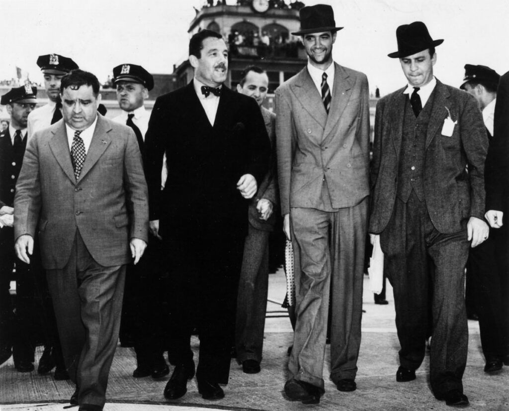 Floyd Bennett Field Howard Hughes (2nd from R) with Mayor La Guardia, Grover Whalen after Hughes return from round the world flight 1938. (Cradle of Aviation Museum)
