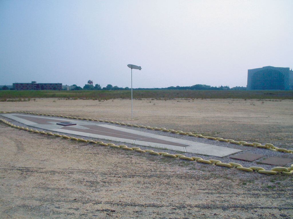The Hindenburg New York Airport Current marker at the disaster site, shown with hangar No. 1 in background.