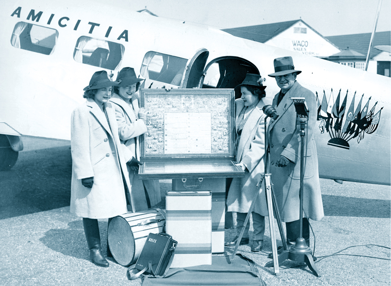 The Flying Hutchinsons New York Airport The Hutchinson Family Goodwill Round-the-World Flight with scroll before the Lockheed Electra ‘Amicitia’ at Roosevelt Field,L.I.