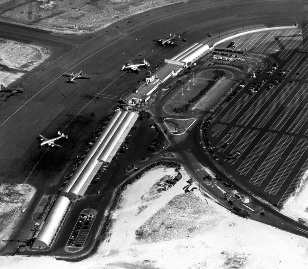 Idlewild-Kennedy Aerial view of temporary terminal buildings and parking areas. Three Lockheed Constellations are parked at terminals. Taxiing is a Douglas DC-4. (Cradle of Aviation Digital Archives-1948)