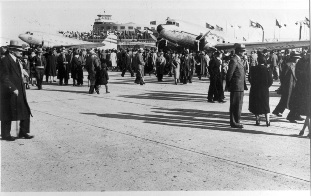 LaGuardia Crowds at airport ramp area with two Douglas DC-3s during the dedication of New York Municipal Airport, October 15, 1939. (Cradle of Aviation Museum)
