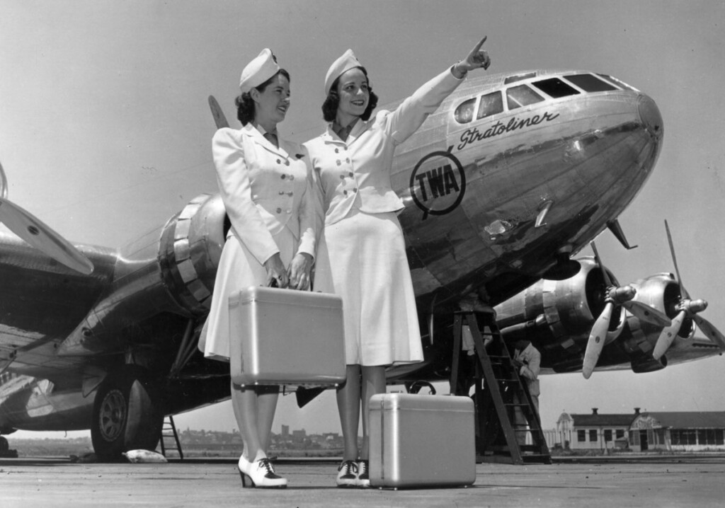 TWA Stewardesses in front of Boeing 307 Stratoliner with Mechanic Working on Engine at LaGuardia Airport