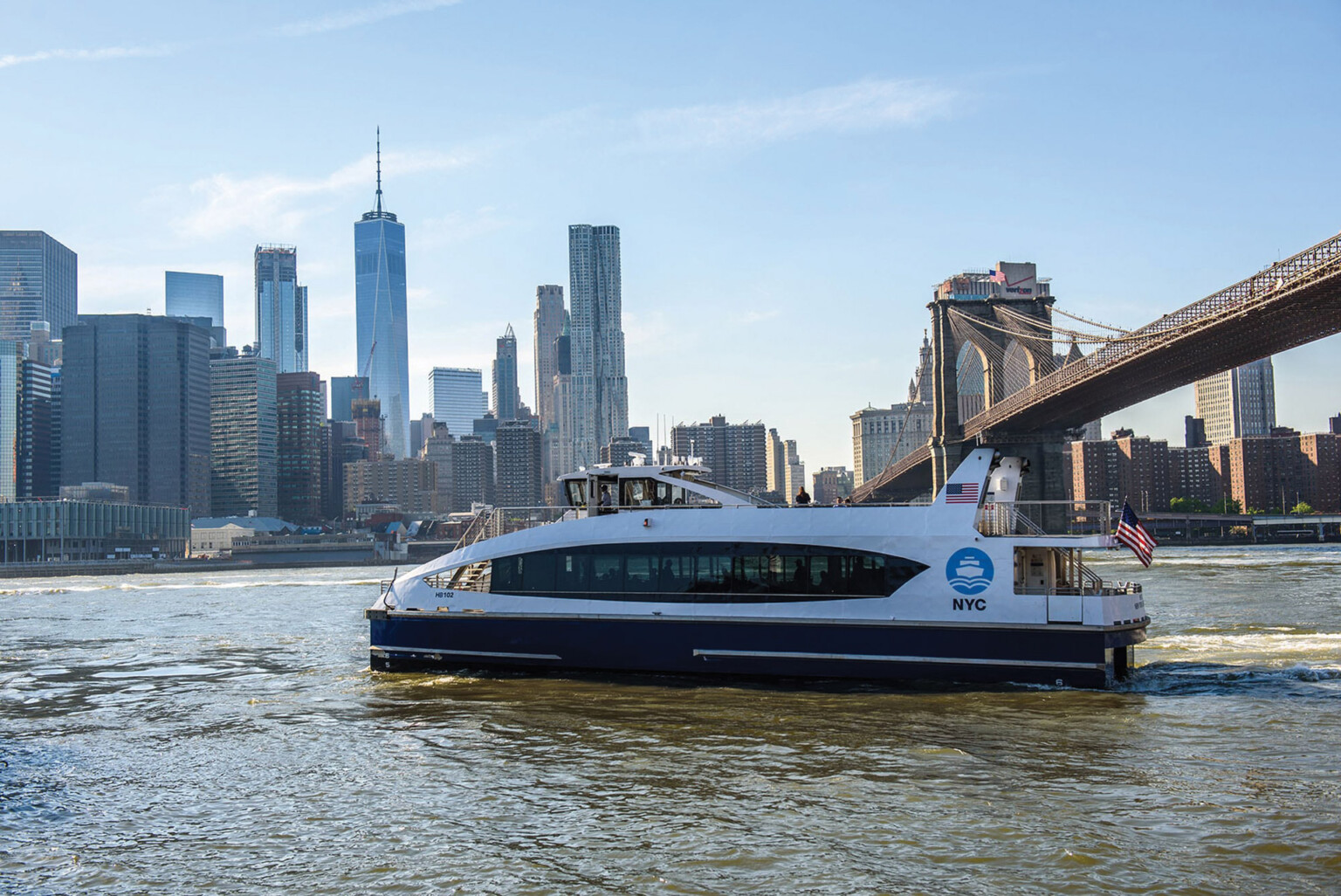 NYC Ferry and Downtown Manhattan Skyline with Brooklyn Bridge