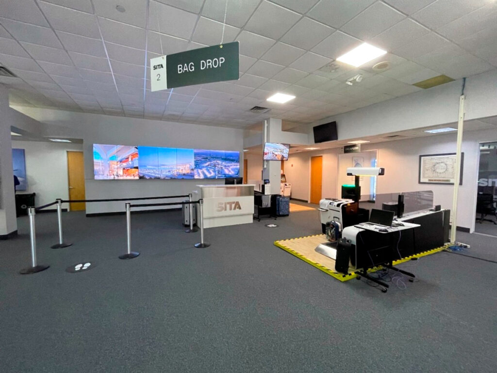 The entryway into the pre-production facility, featuring check-in desks and information displays.