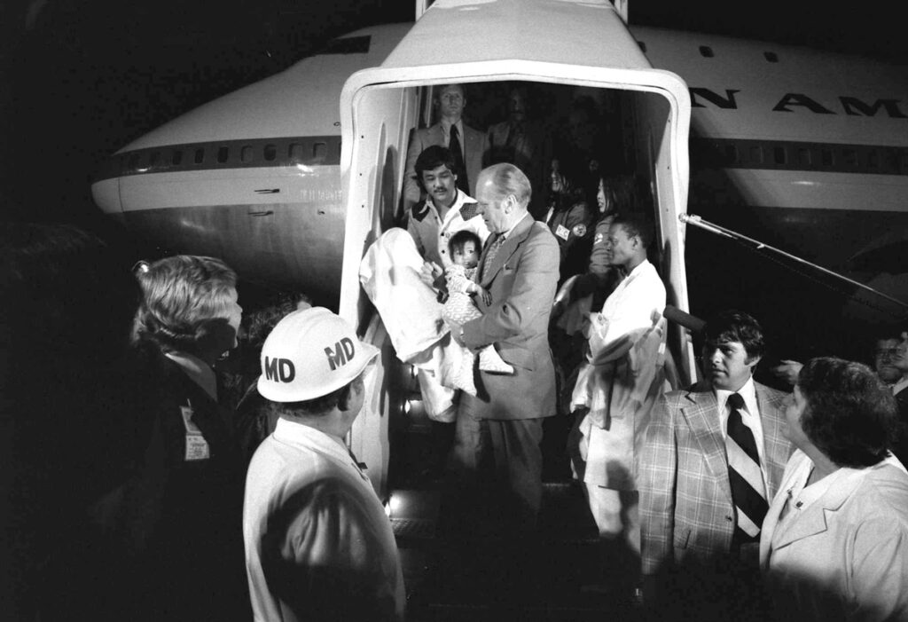 Operation Babylift 50th Reunion: A Celebration of the Human Spirit President Gerald R. Ford Carrying a Vietnamese Baby from "Clipper 1742"
