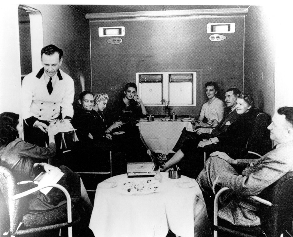 Travel By Air, The Golden Years: 1920s-1960s New York Airport Steward serving drinks to a passenger in lounge of Boeing 314 c.1940 Metropolitan Airport News