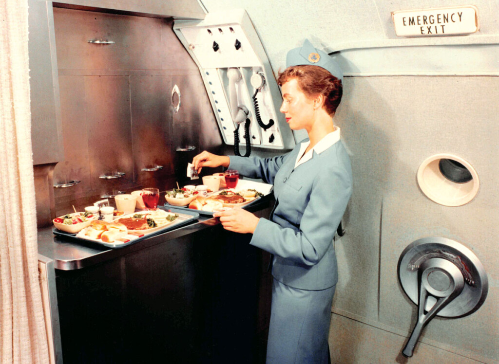 Travel By Air, The Golden Years: 1920s-1960s New York Airport A Pan Am stewardess prepares meals in the galley of a Boeing 707 c1961