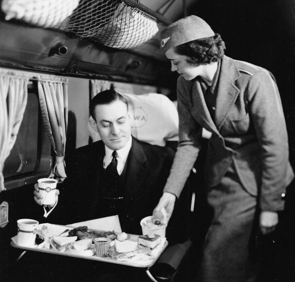 Stewardess serving passenger on board TWA DC-2 c.1935 (Cradle of Aviation Museum)