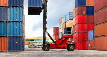 Alba Wheels Up Elevates Global Logistics Offering with the Acquisition of VT Mancusi Crane lifting up container in yard
