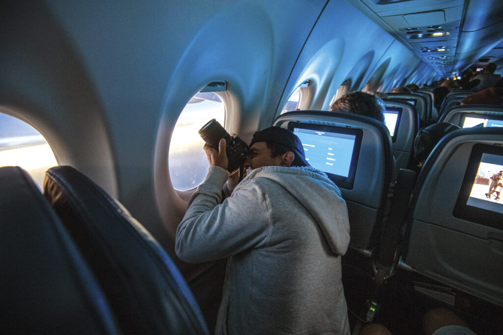 Gazing Skyward... New York Airport Delta Air Line passengers photograph the eclipse during an eclipse flight from AUS to DTW.